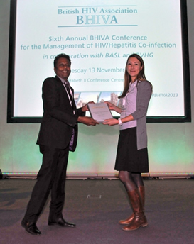 Dr Ranjababu Kulasegaram (left) presents Dr Emilie Elliot (right) with the BHIVA Best Difficult HIV/hepatitis co-infection case presentation